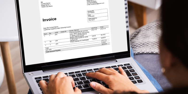 Laptop showing invoice for paying contractors