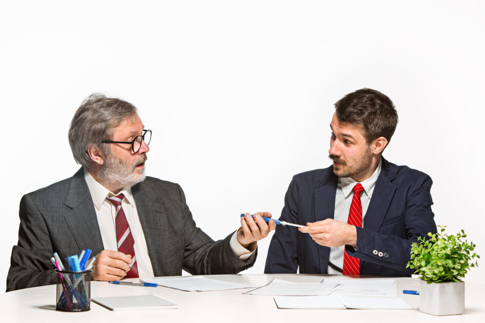 The two colleagues working together at office on white background.