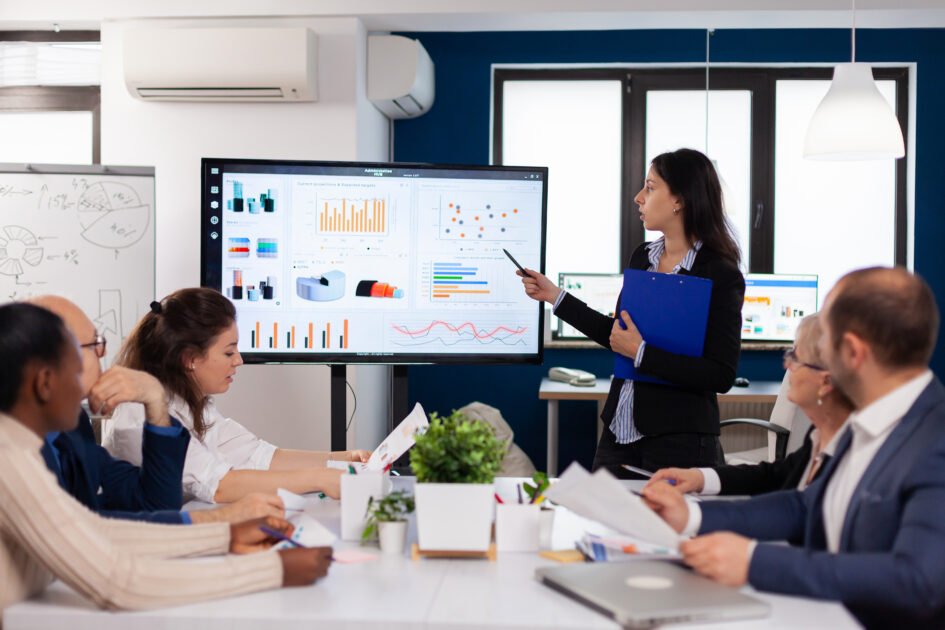 Young team leader in big corporation briefing coworkers