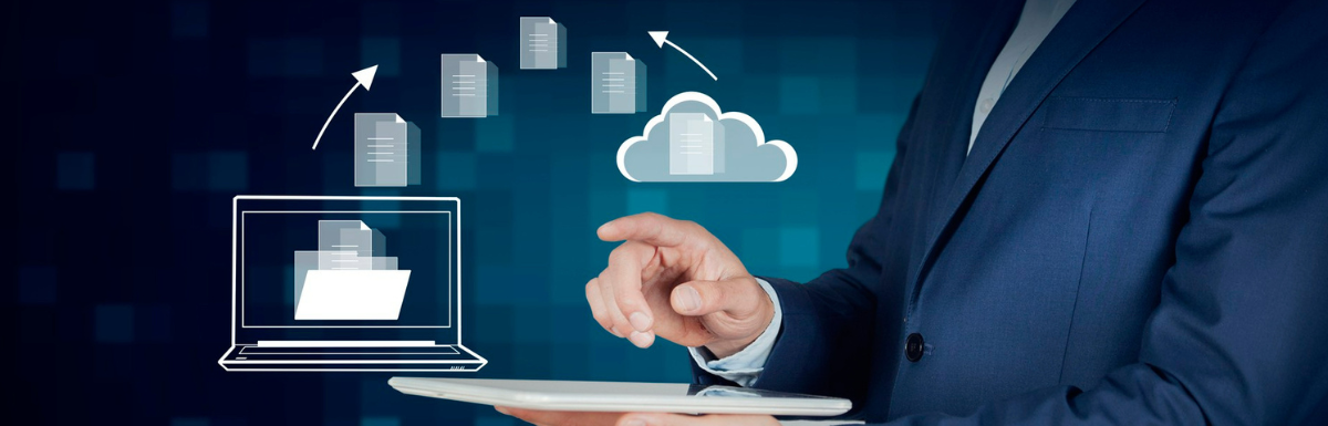 A man in a suit securely copies cloud icons from a tablet.