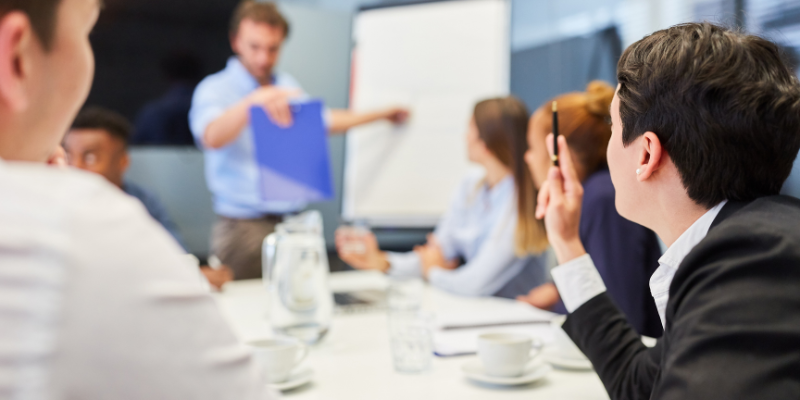 A group of business people discussing chatops at a meeting.