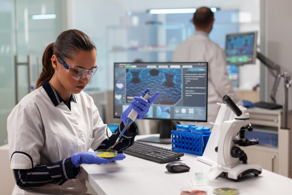 Doctor scientist conducting clinical experiment using micropipette