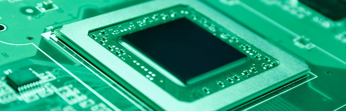 A close up of a green circuit board.