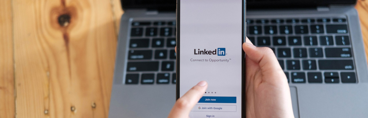 A person holding an iPad connected to a LinkedIn post generator.