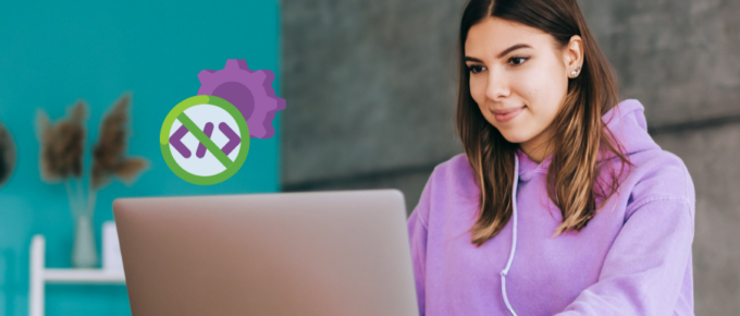 A woman is sitting in front of a laptop with gears on it.