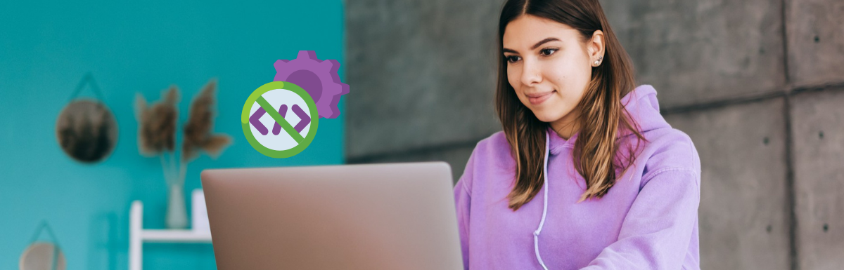 A woman is sitting in front of a laptop with gears on it.