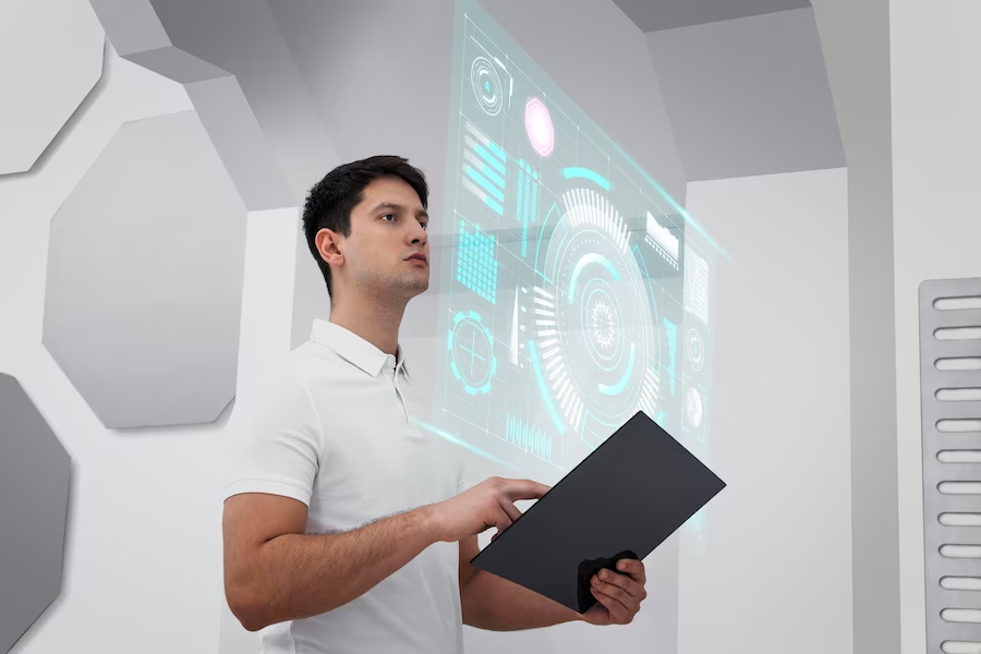 A man looking at a computer screen in a futuristic room.