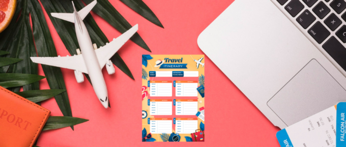 A laptop on a table with itinerary templates next to an airplane and other items.