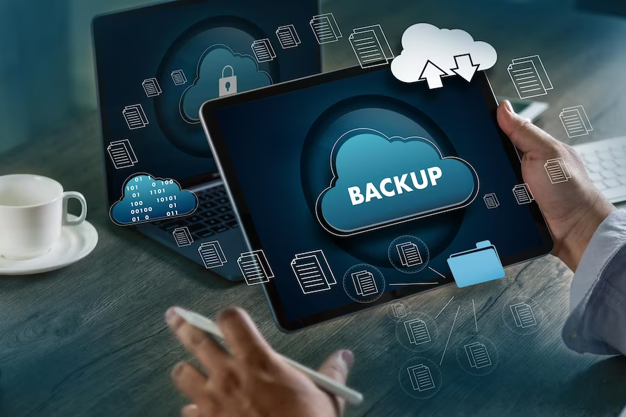 A person holding a tablet with the word backup on it.