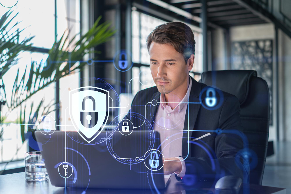 A man in a suit is using a laptop with a security symbol on it.