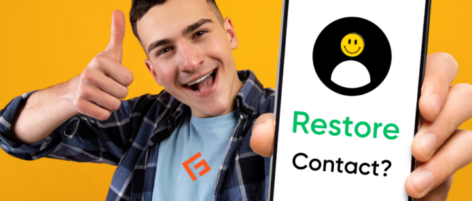 A man holding up a phone with the word restore contact on it.