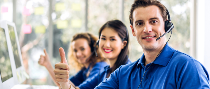 A team in a contact center giving thumbs up.