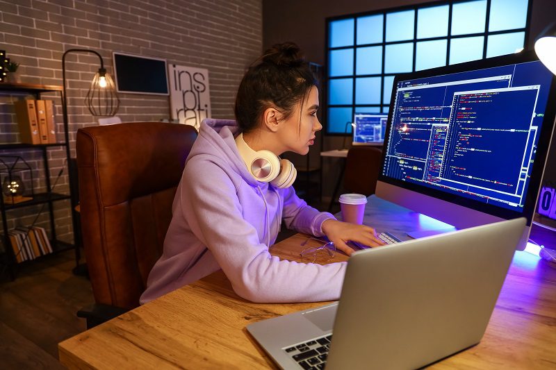 Young female programmer working in office