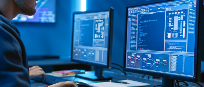 A man is using a database IDE in a dark room.