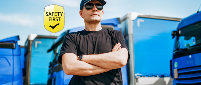 A man with ELD Compliance Solutions standing in front of a truck with his arms crossed.