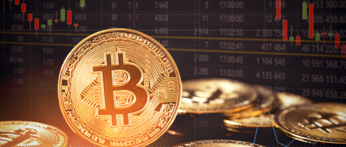 Bitcoin coins in front of a stock chart.