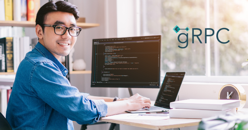 A man sitting in front of a computer with the grpc logo.