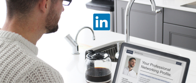 A man is using a laptop to review his LinkedIn profile after using profile summary generators.