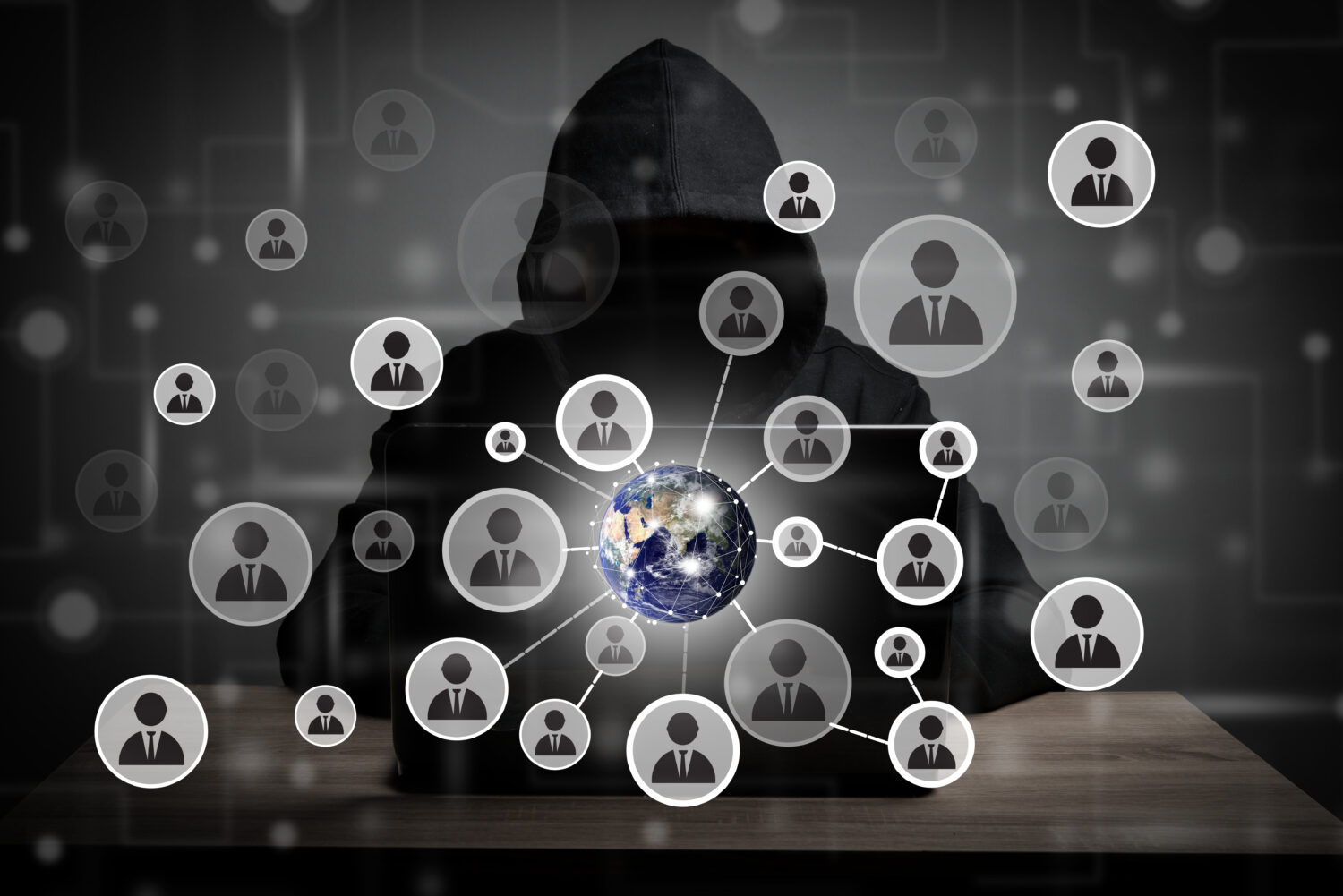 Image of hacker man with people icon and code around on screen.