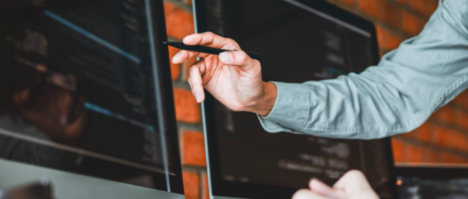 A man is using WebSocket Testing Tools to point at a computer screen.