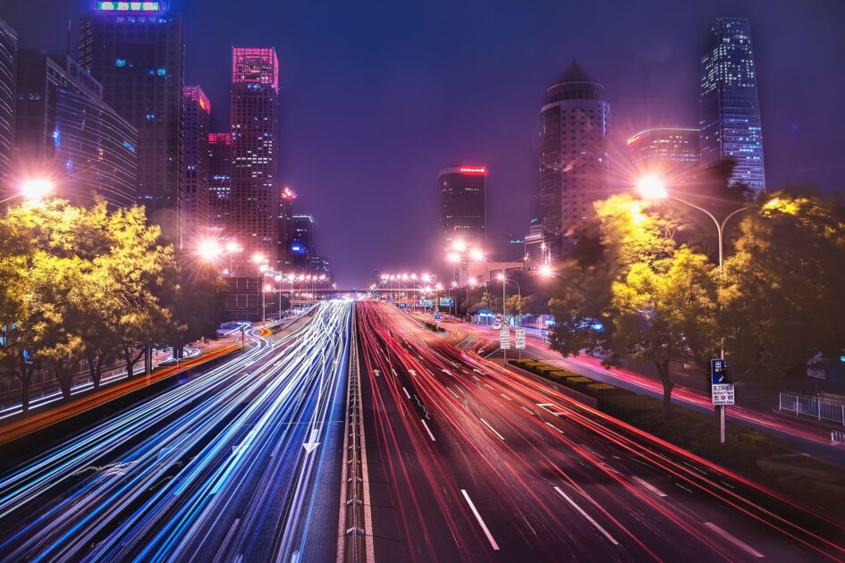 Timelapse photo of a highway showing red and blue lines